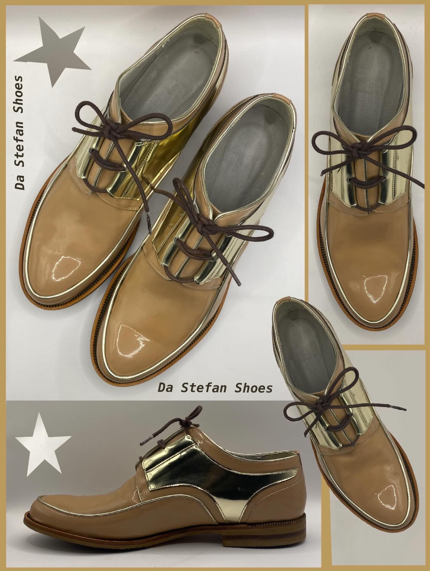Tan leather shoes with gold accents and brown laces.