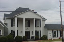 A large building with a lot of parking in front of it