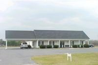 A large brick building with a carport in front of it