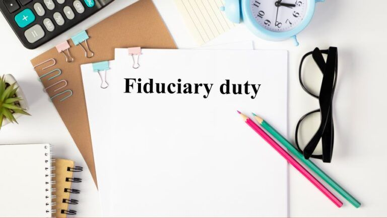 Fiduciary duty text on a white desk with glasses, pencils, notebook, clock, and plant.