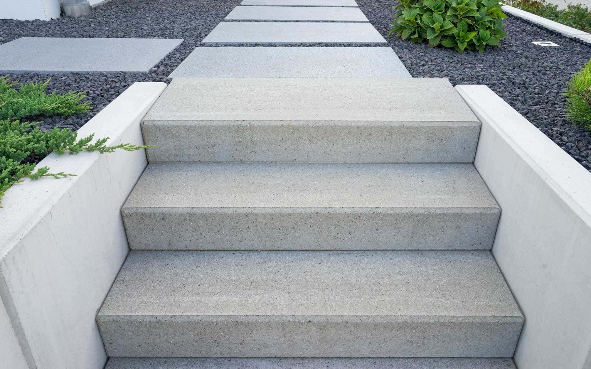 A set of concrete steps leading up to a walkway.