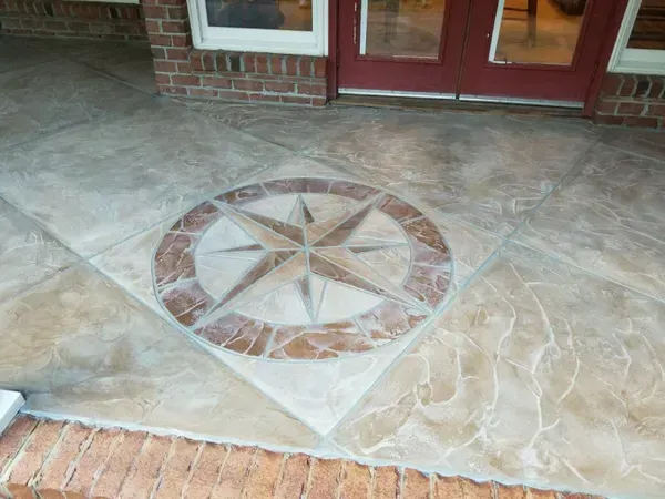 A concrete porch with a compass design on it.