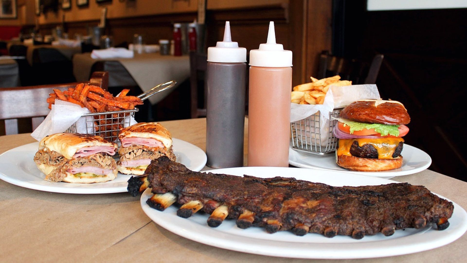 BBQ ribs with sauces on table