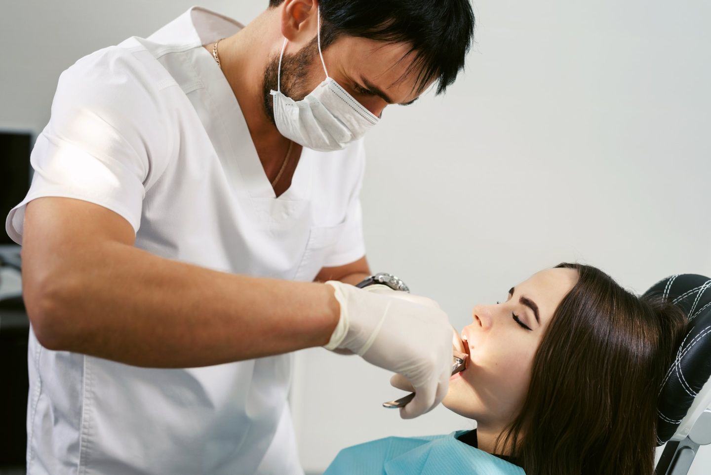 Male Doctor Performing Extraction - Dental Treatments in Port Macquarie, NSW