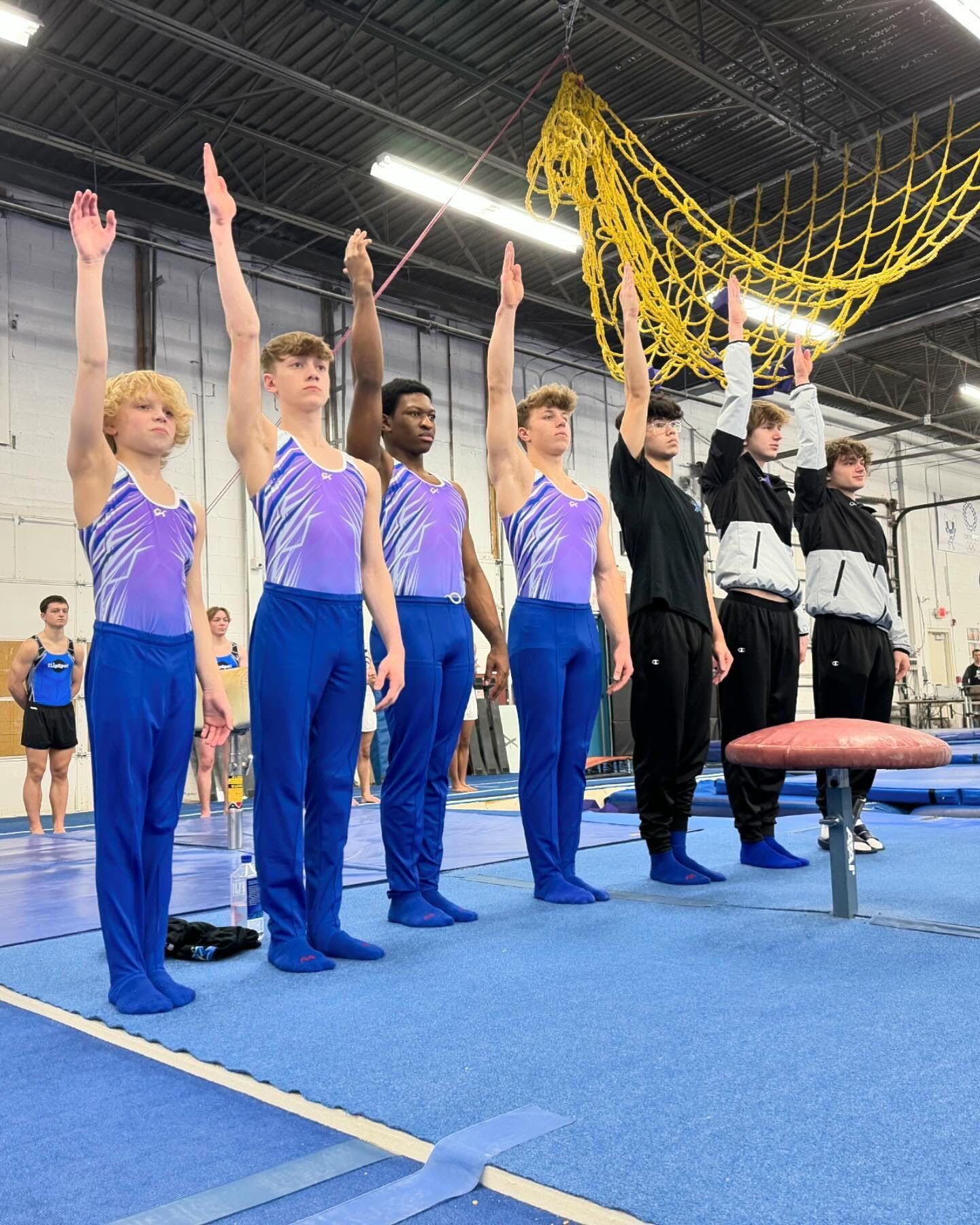 a group of young people are posing for a picture in a gym