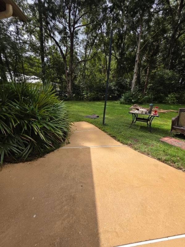 A white house with a patio in front of it.