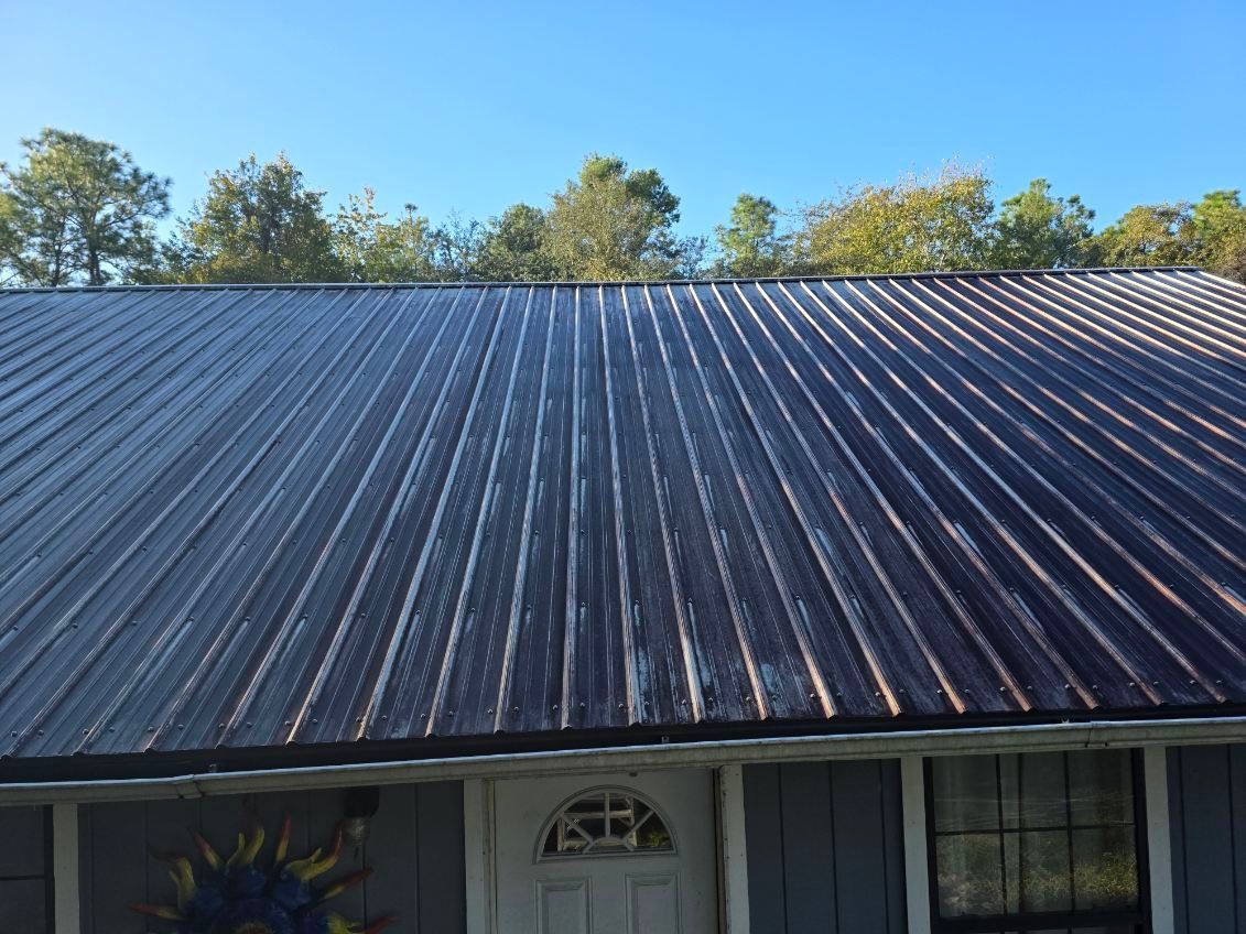 A curb on the side of a road with a manhole cover on it.