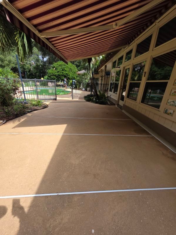 A white house with a patio in front of it.