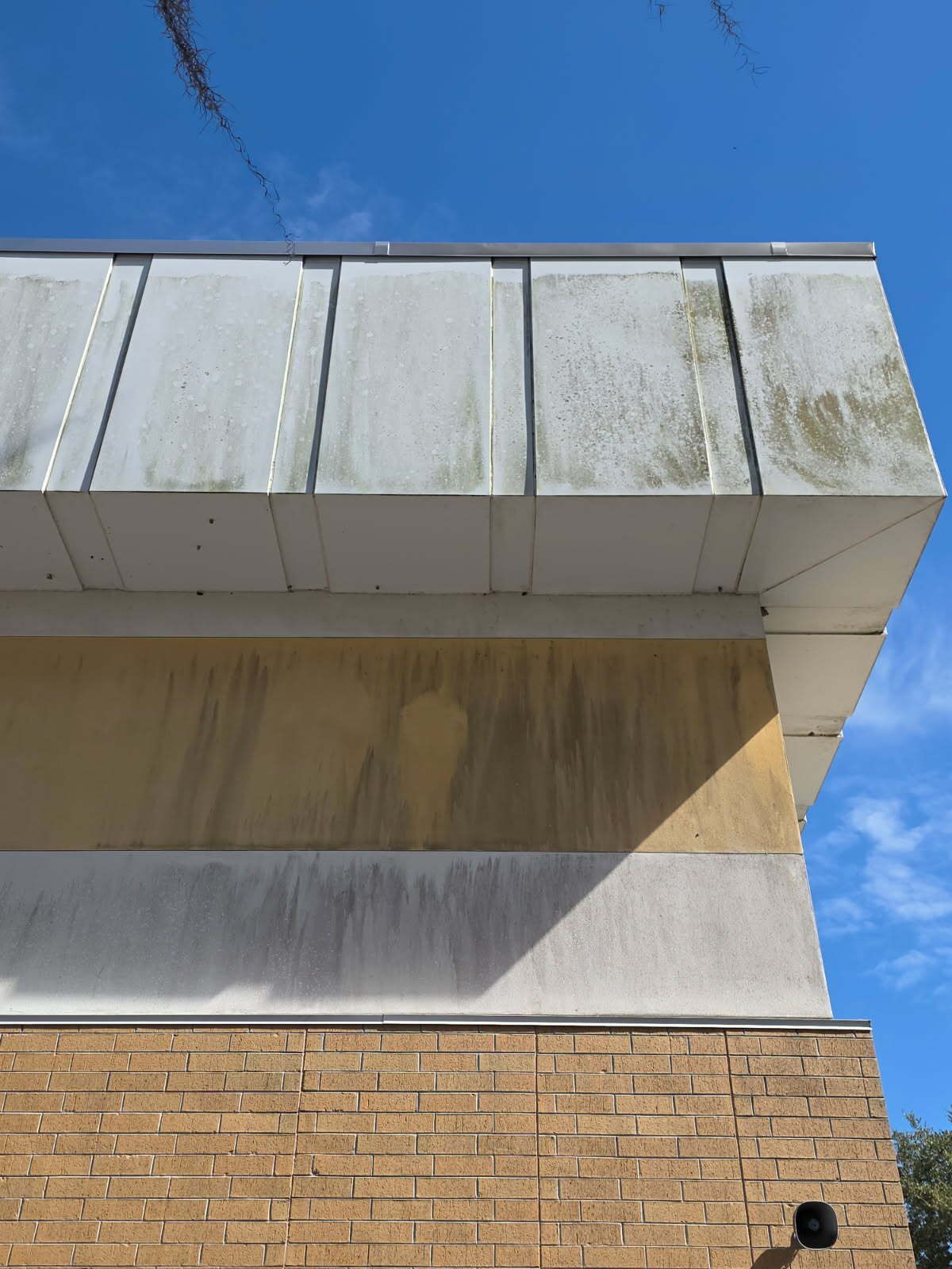 A statue of a man standing next to a wooden bench.