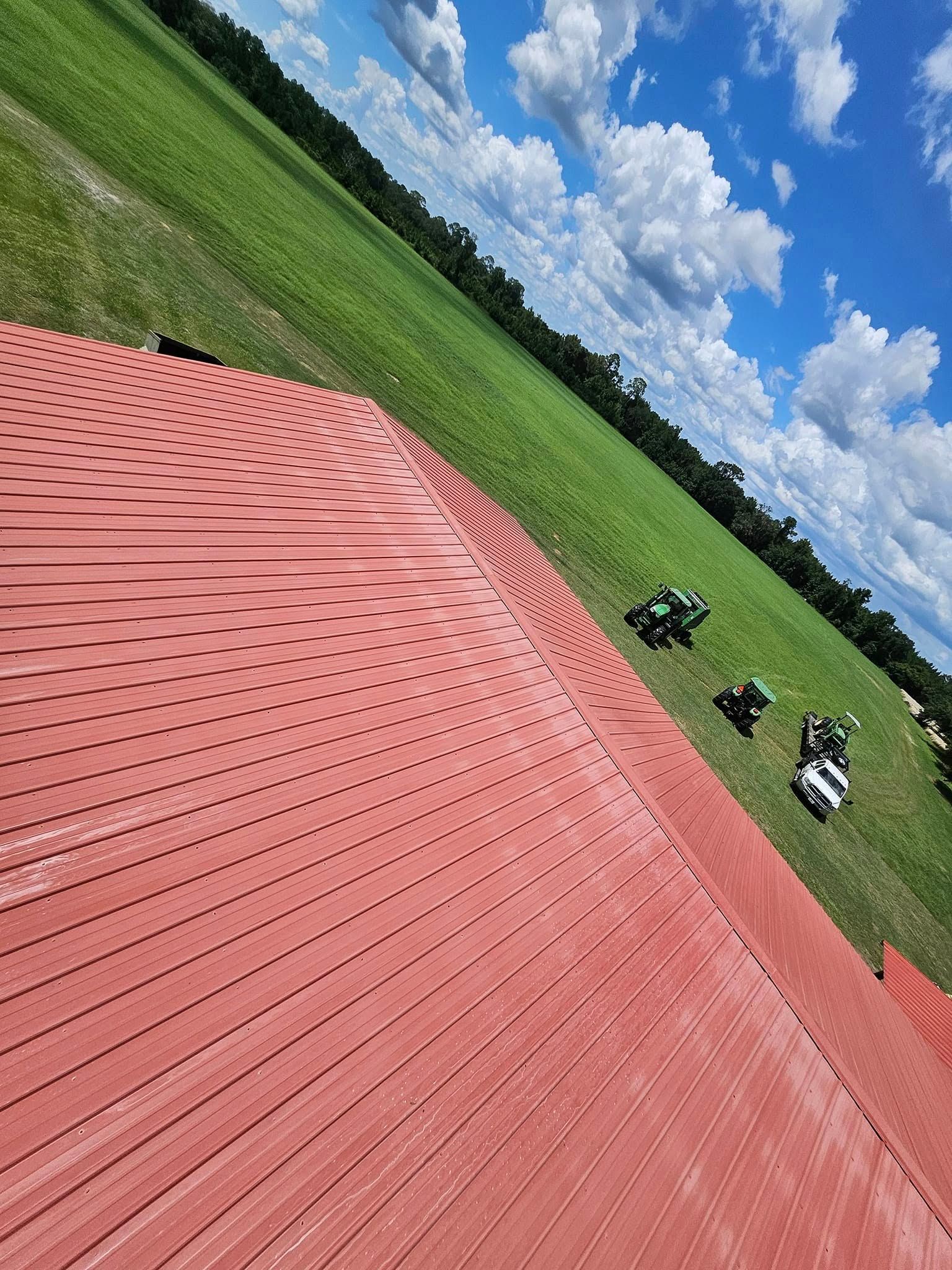 A red carpet is sitting in the middle of a grassy field.
