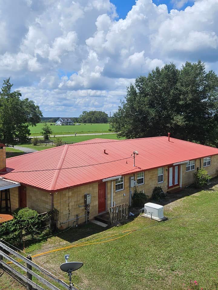 An aerial view of a house with a red roof