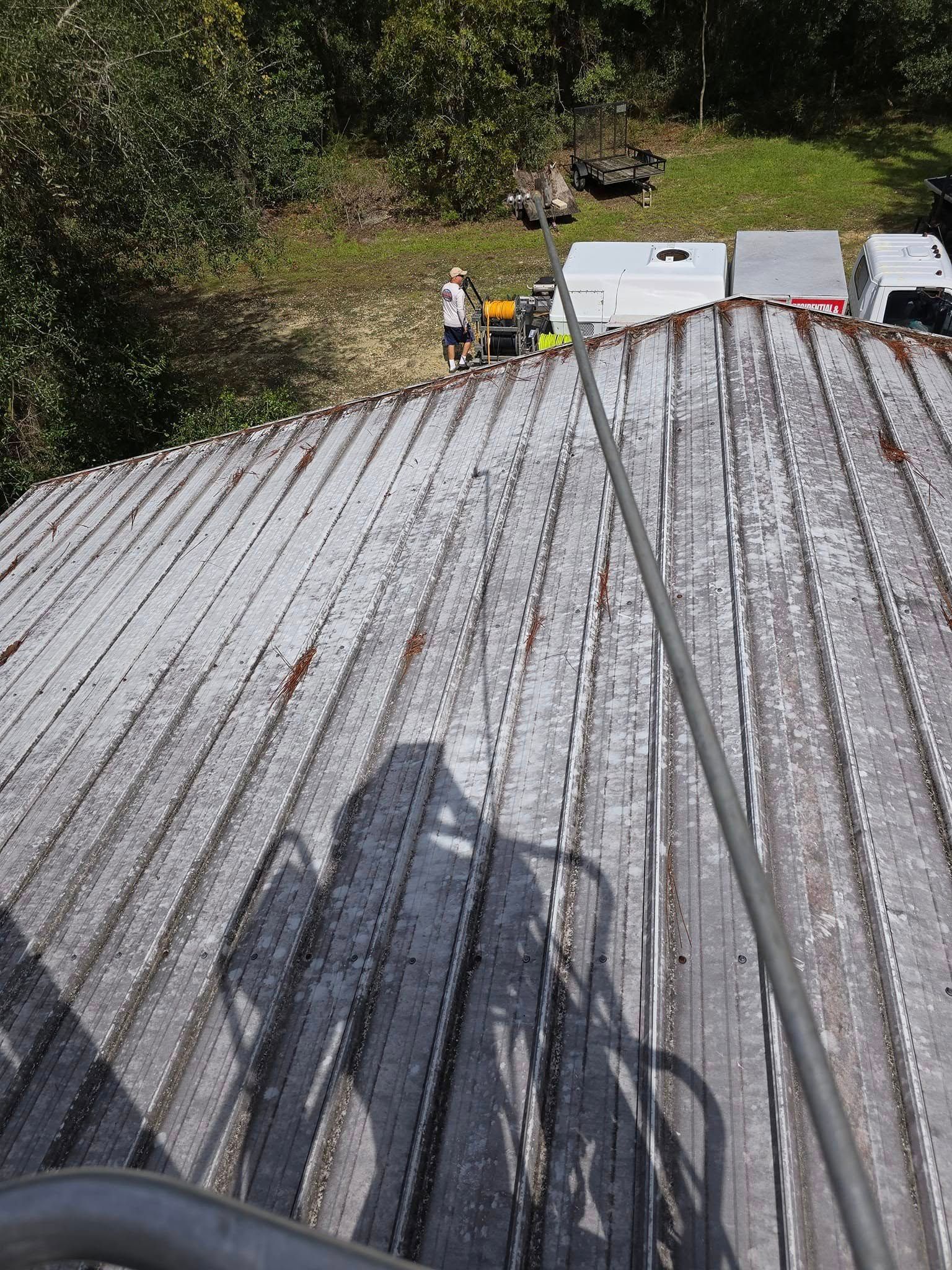 A person is standing on the roof of a building.