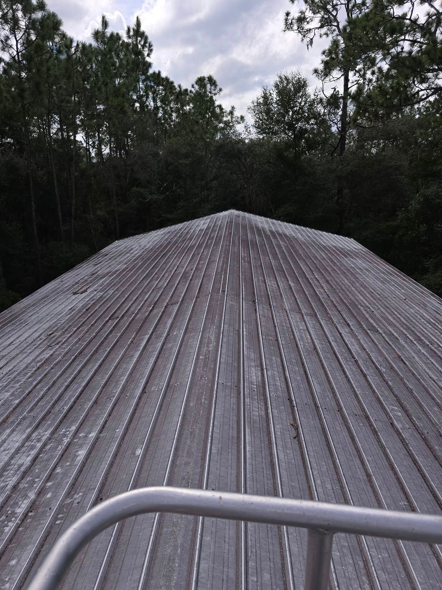 The roof of a building with trees in the background