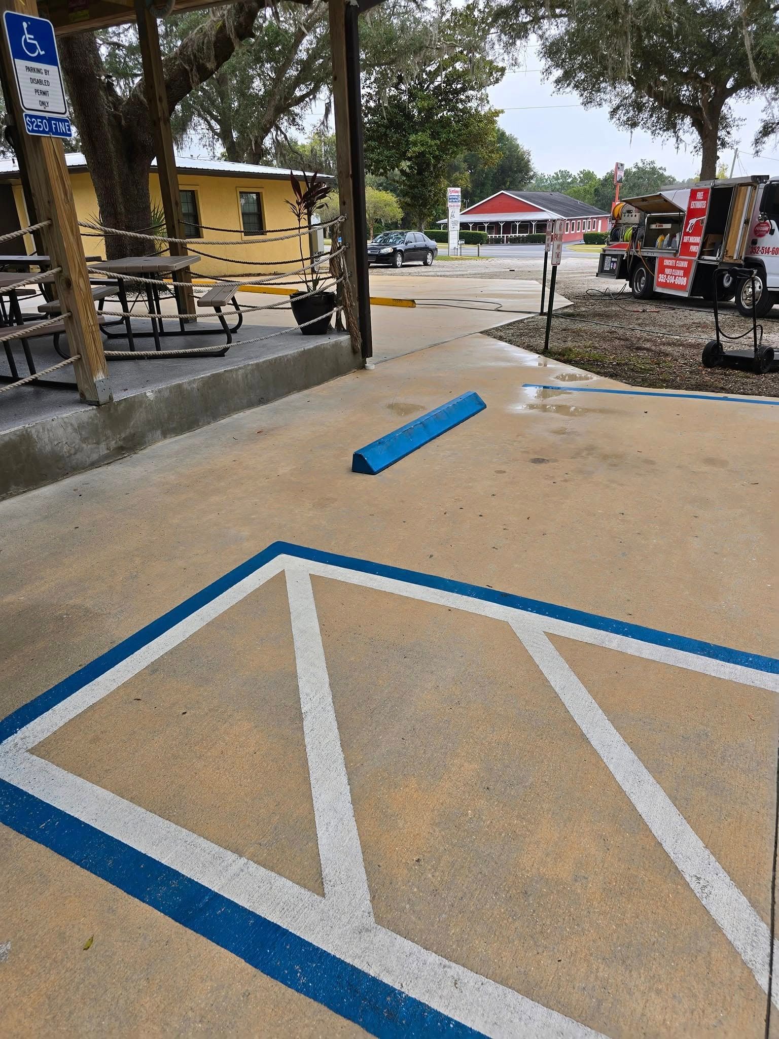 A handicapped parking spot with a blue and white stripe on the ground