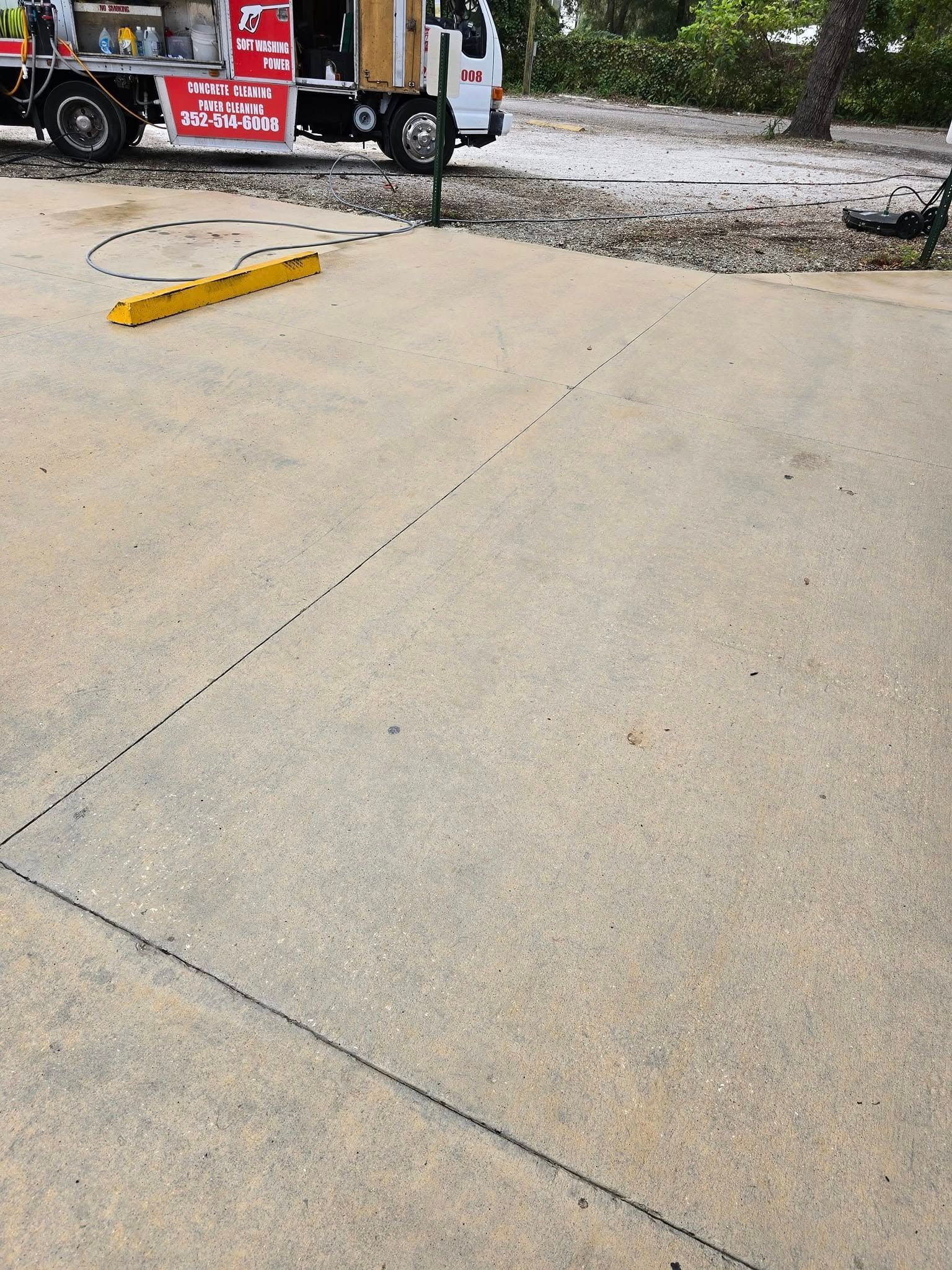 A red and white truck is parked in a parking lot.