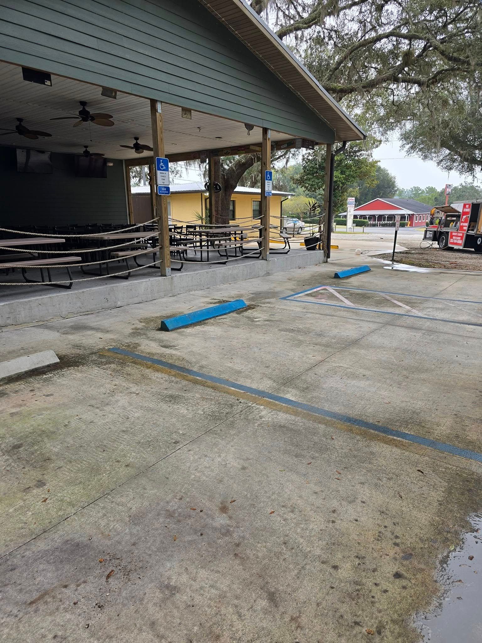 A picnic area with tables and benches under a covered area.
