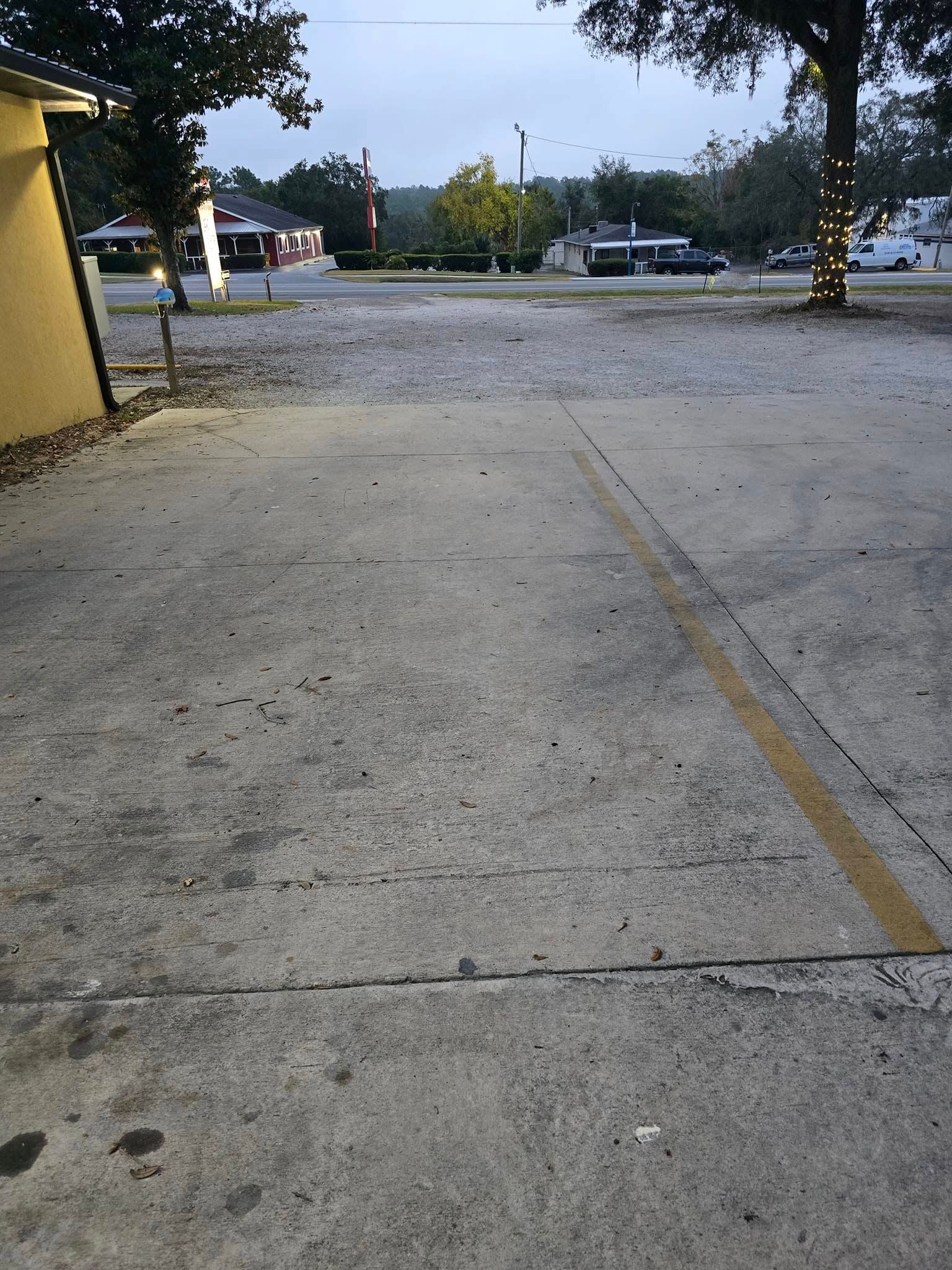 A parking lot with a yellow line on the side of it.