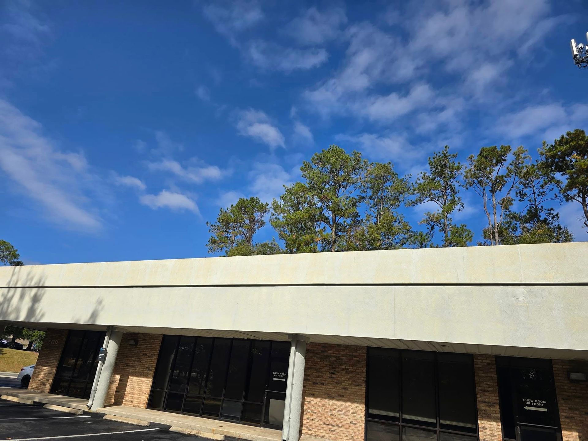 A building with a blue sky and clouds behind it
