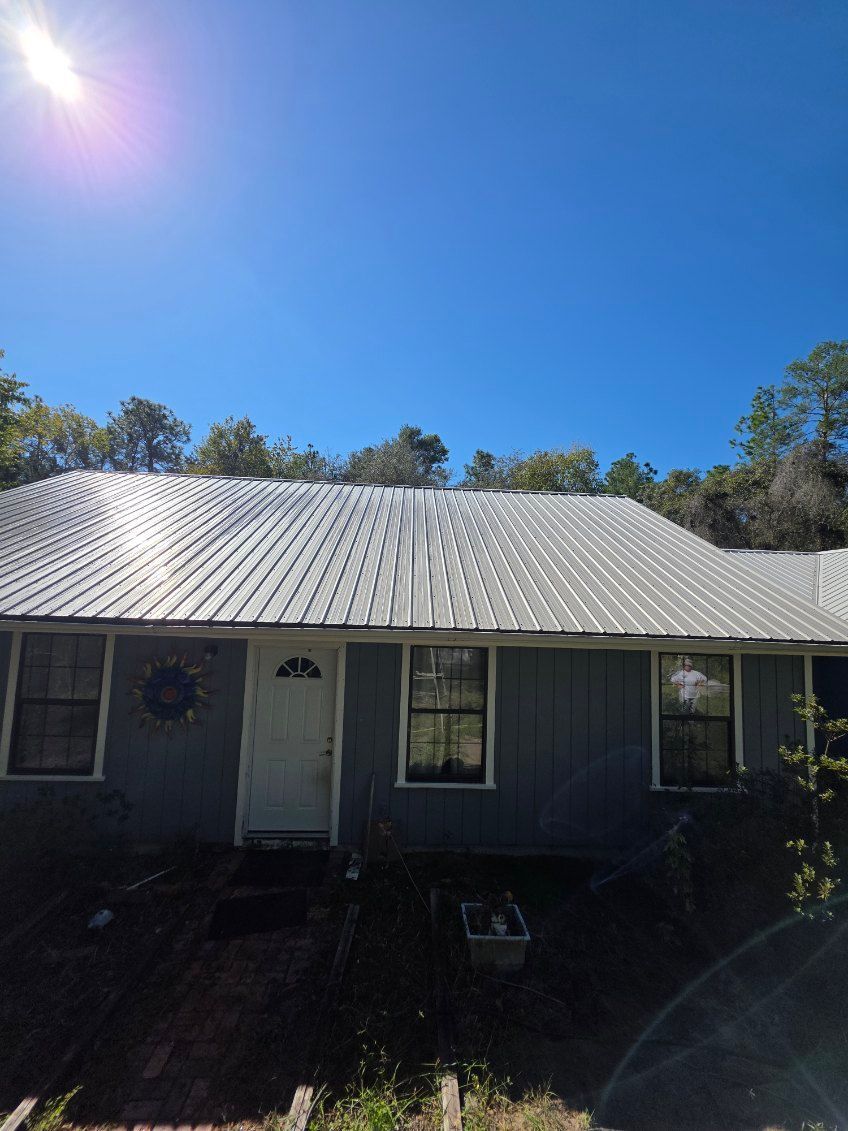 A curb on the side of a road with a manhole cover on it.