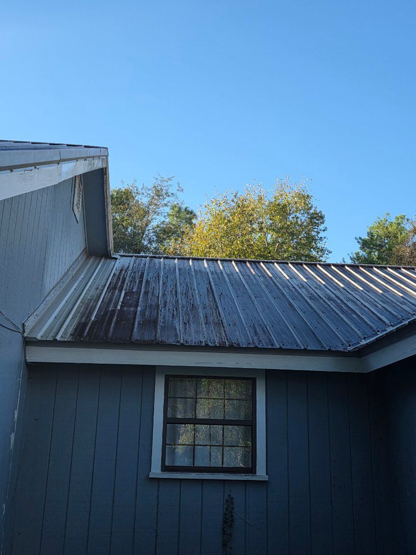 A curb on the side of a road with a manhole cover on it.