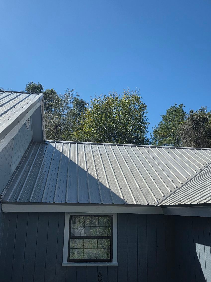 A curb on the side of a road with a manhole cover on it.