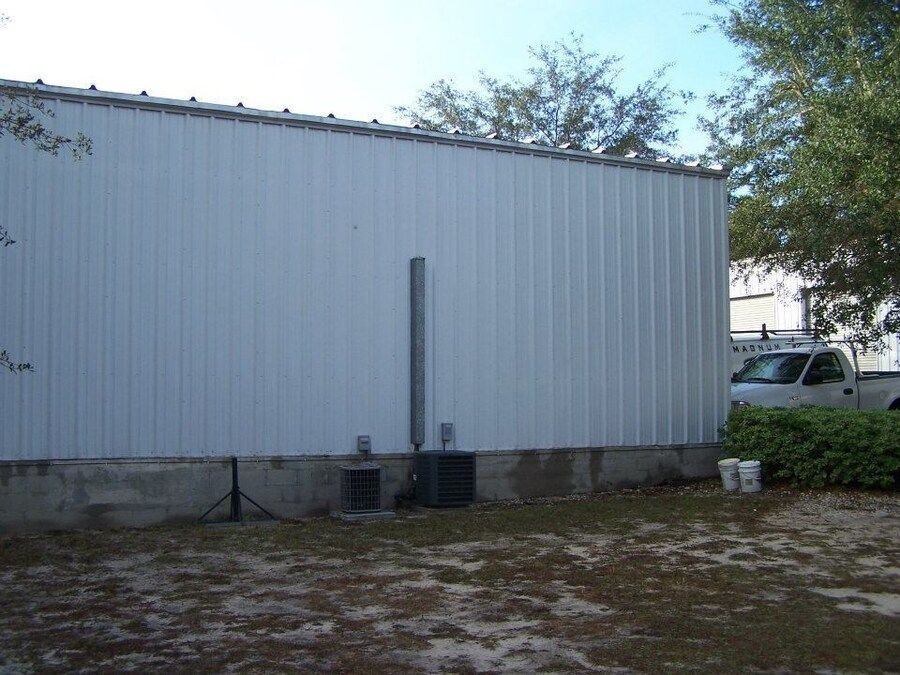 A large house with a garage and a driveway in front of it.