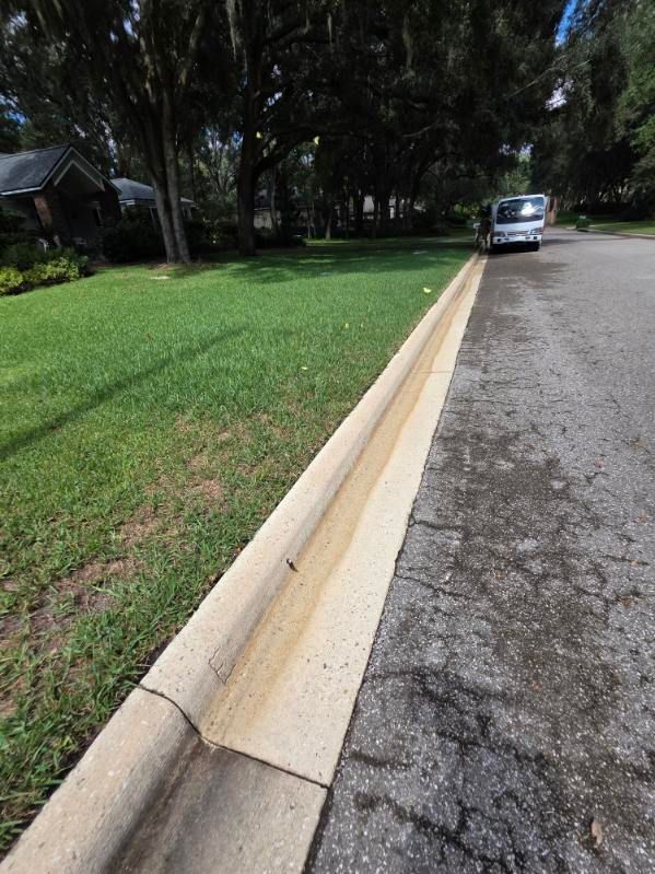 A motorcycle is parked in front of a building with the number 13 on it
