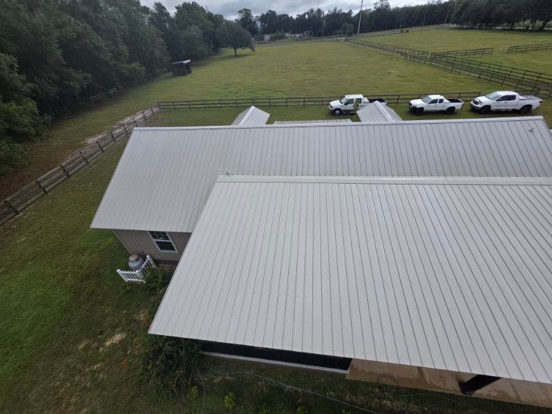 A red motorcycle is parked in front of a white building