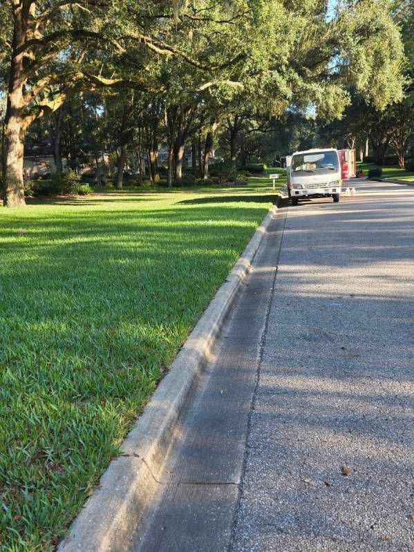A red motorcycle is parked in front of a white building