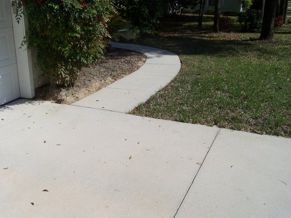 A large house with a lot of windows and a garage on a rainy day.