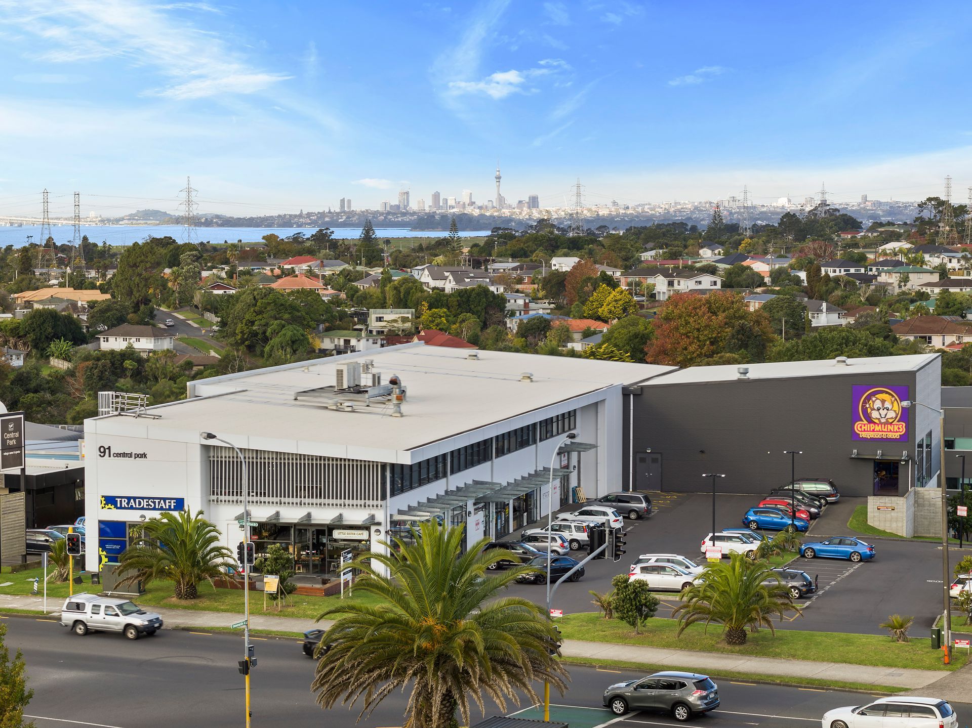 An aerial view of a large building with cars parked in front of it.