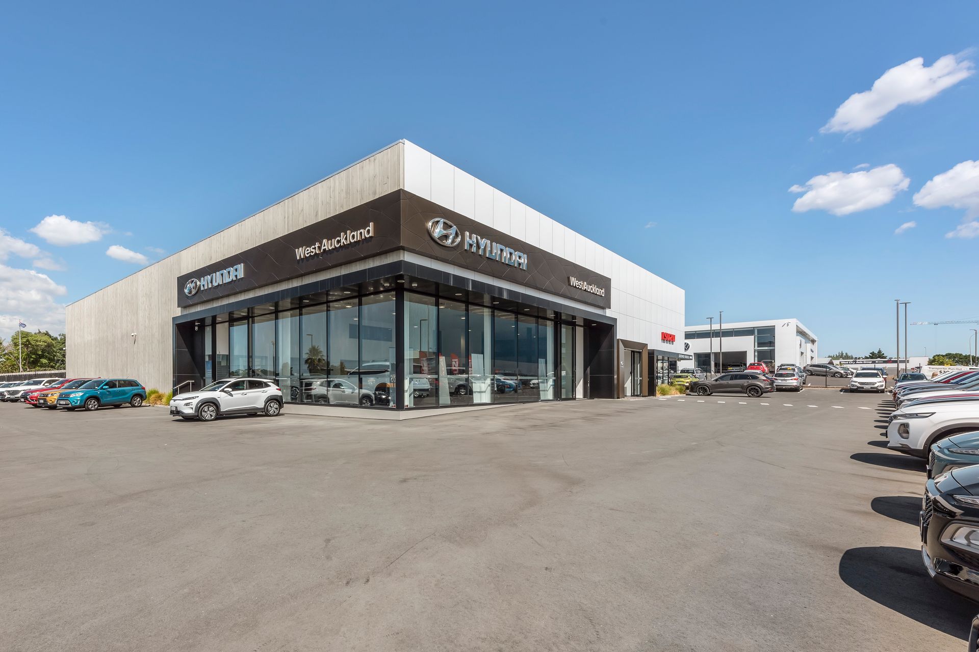 A car dealership with a lot of cars parked in front of it.