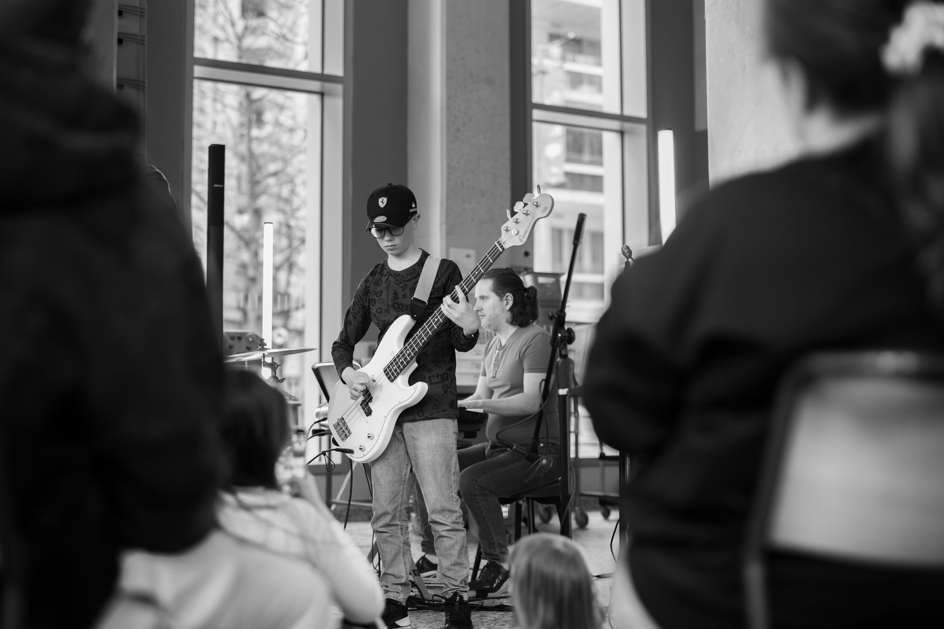 A man is playing a guitar in front of a crowd of people.