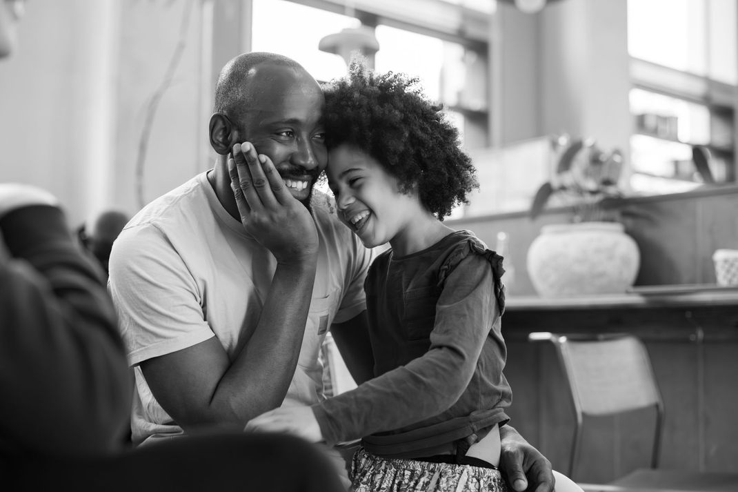 A black and white photo of a man and a little girl.