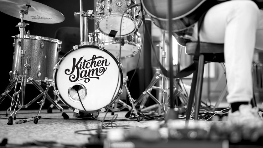 A black and white photo of a person playing a drum set.