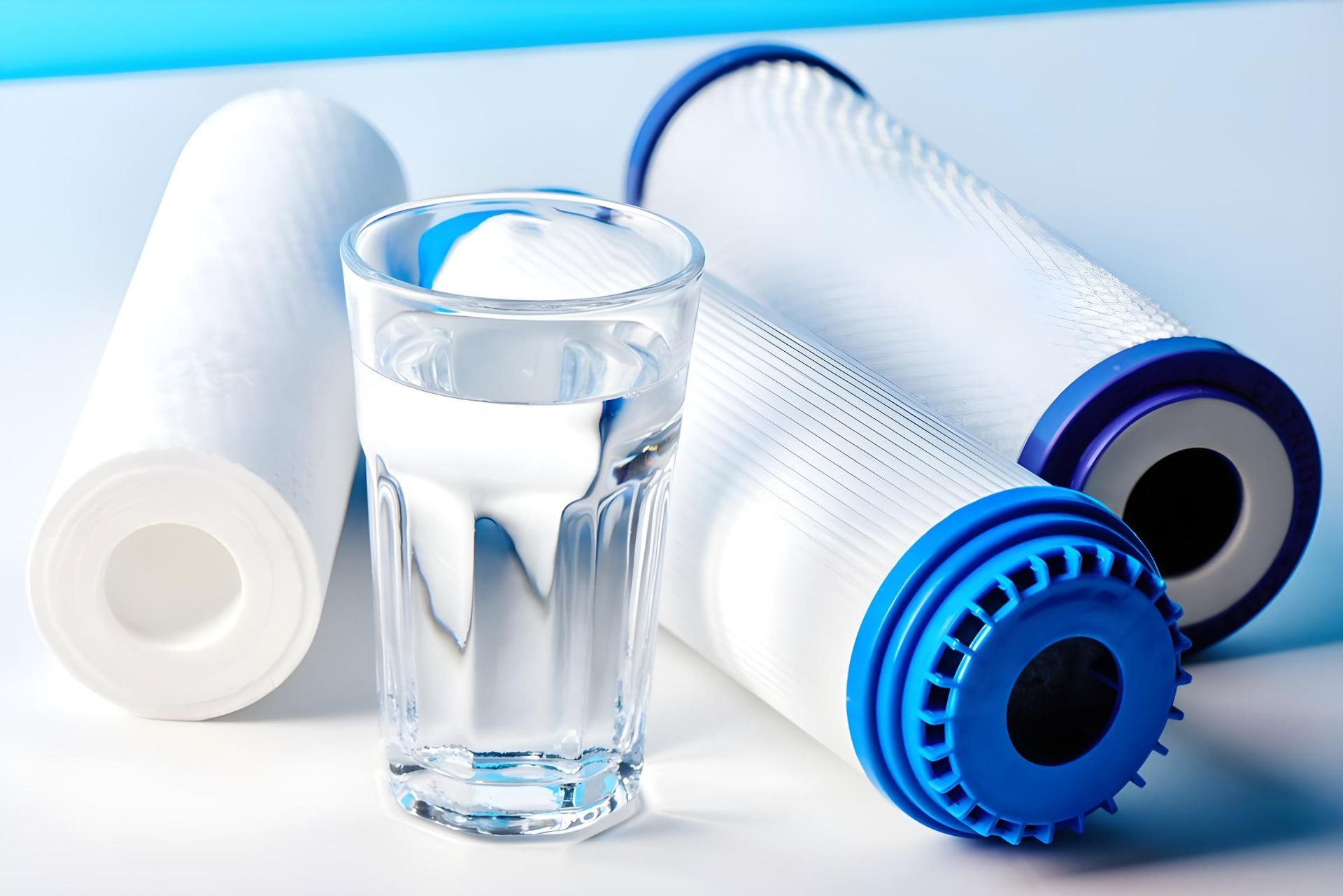A Glass of Water Surrounded by Water Filters on a Table — NT Water Filters In Winnellie, NT