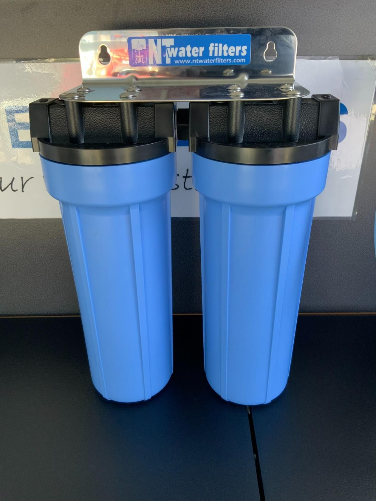 Two Blue Water Filters Are Sitting on a Table — NT Water Filters In Winnellie, NT