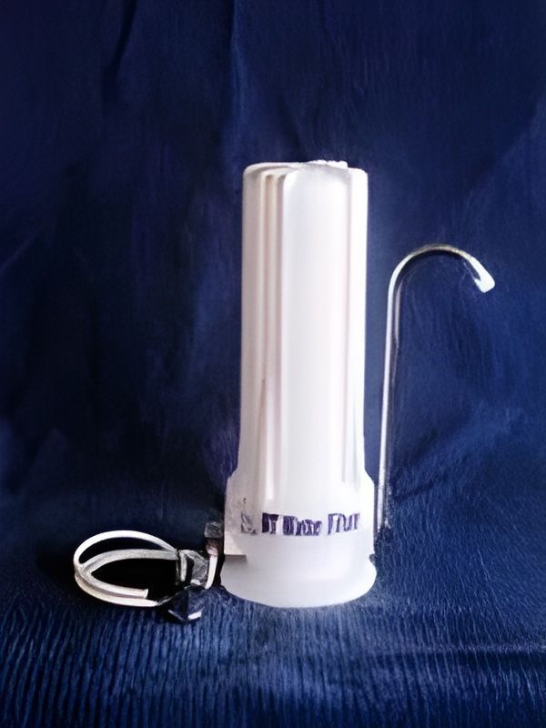 White water filter with silver spout and attached white tube on blue fabric. — NT Water Filters In Winnellie, NT