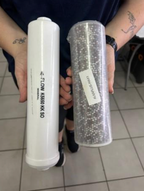 A Person Holds Two Water Filter Cartridges — NT Water Filters In Winnellie, NT