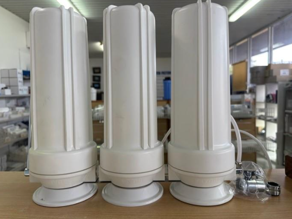 Three White Water Filter Housings Connected, Indoor Setting — NT Water Filters In Winnellie, NT