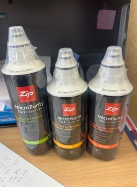 Three Zip Micropurity 7 in 1 Water Filters in Wrappers, on a Desk — NT Water Filters In Winnellie, NT