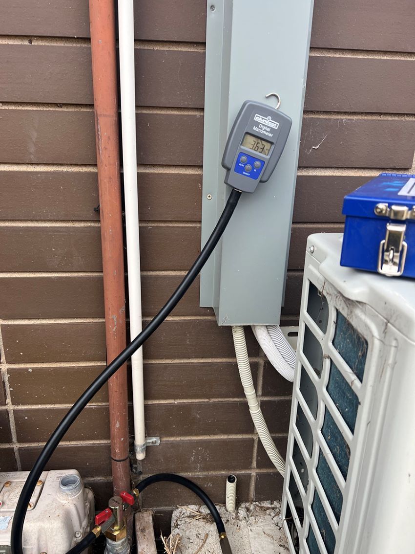 A Digital Thermometer is Attached to a Wall Next to an Air Conditioner — Fig Facility Services in Lara, VIC