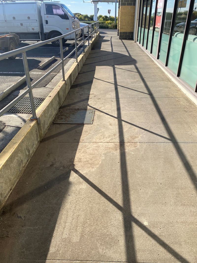 A Concrete Sidewalk With a Railing and Shadows on It — Fig Facility Services in Lara, VIC