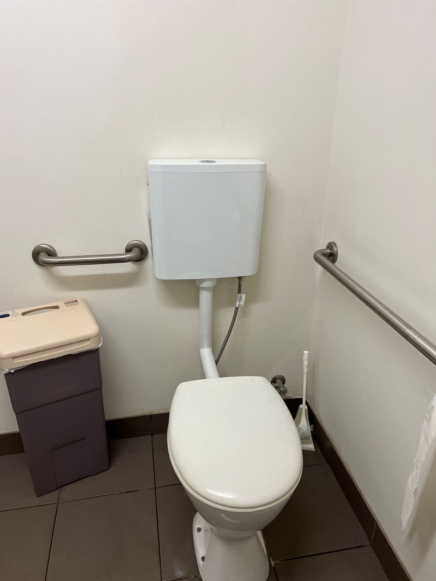 A Man is Working on a Sidewalk With a Shovel — Fig Facility Services in Lara, VIC