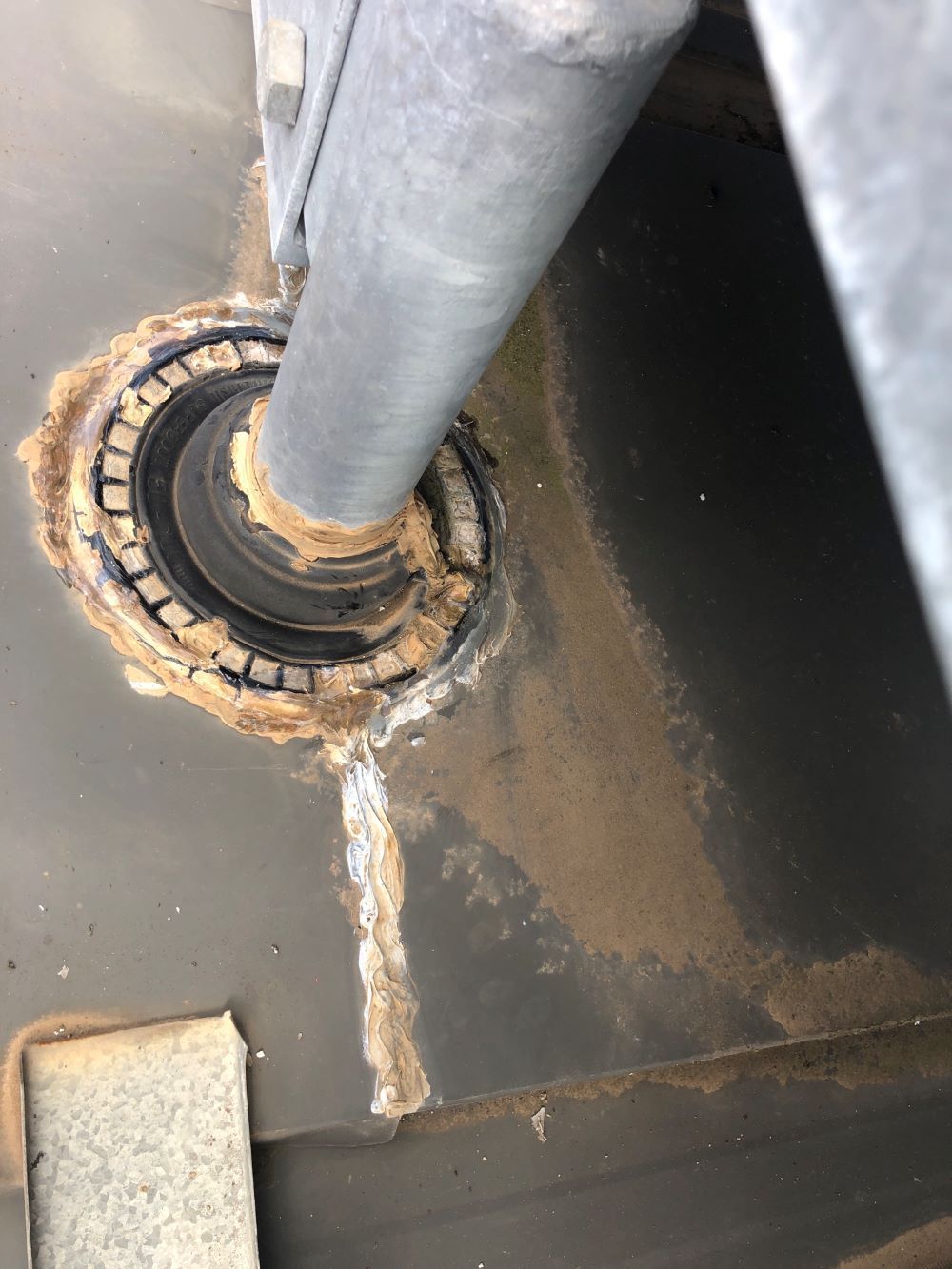 A White Pipe is Attached to a Concrete Wall — Fig Facility Services in Lara, VIC