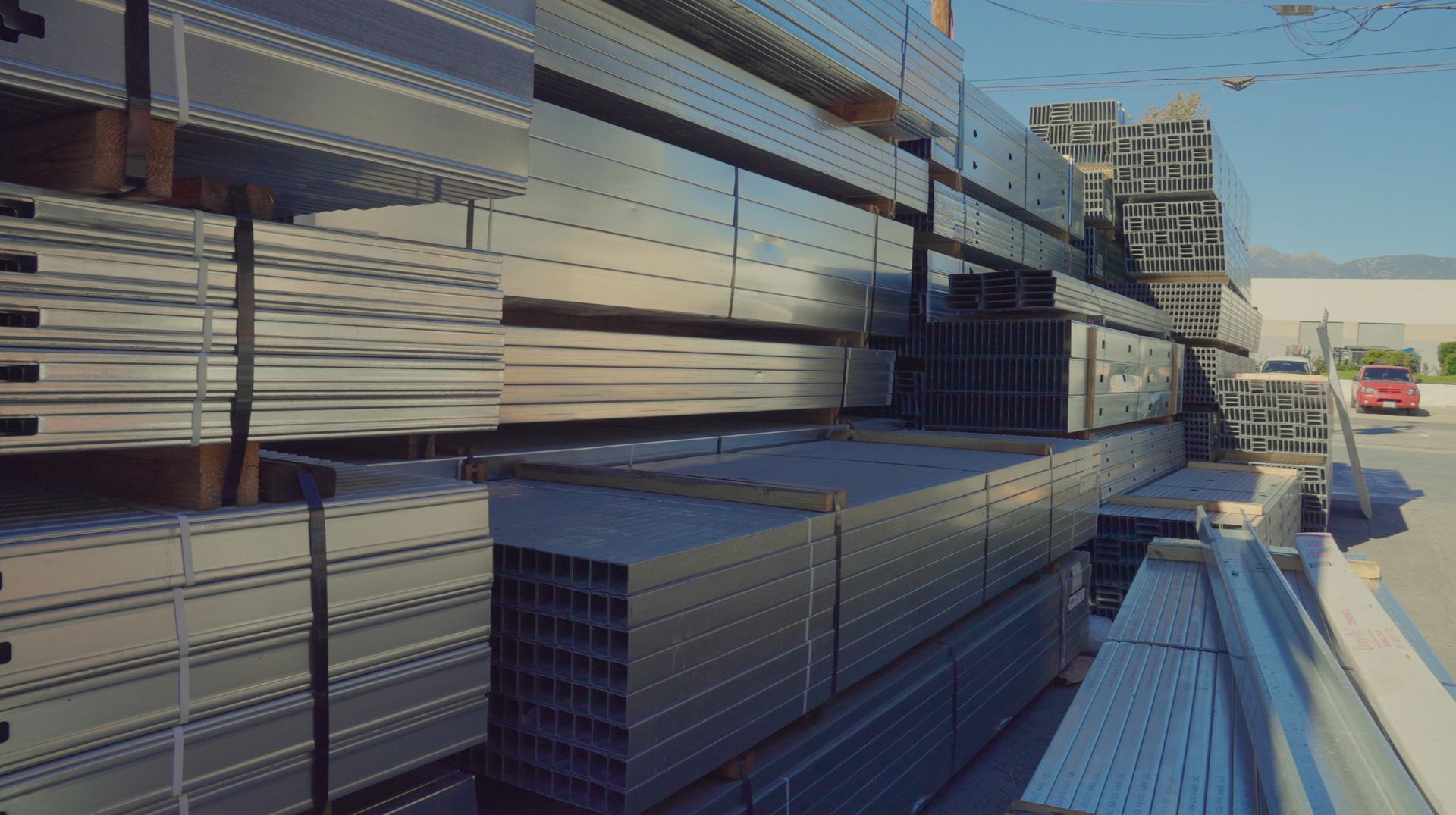 Black step ladders with red and yellow accents are displayed against a dark background.