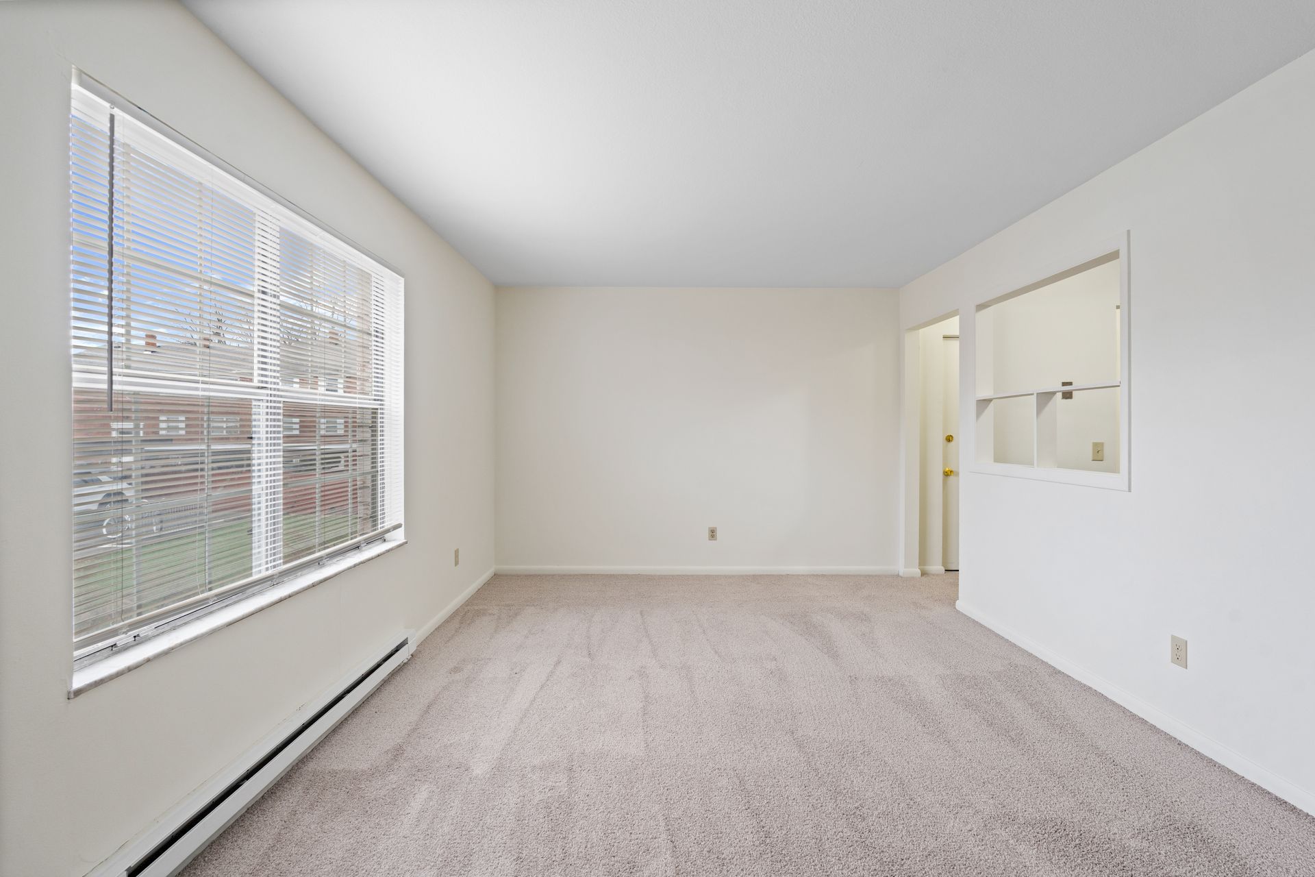 Photo of an empty den showing a wide window