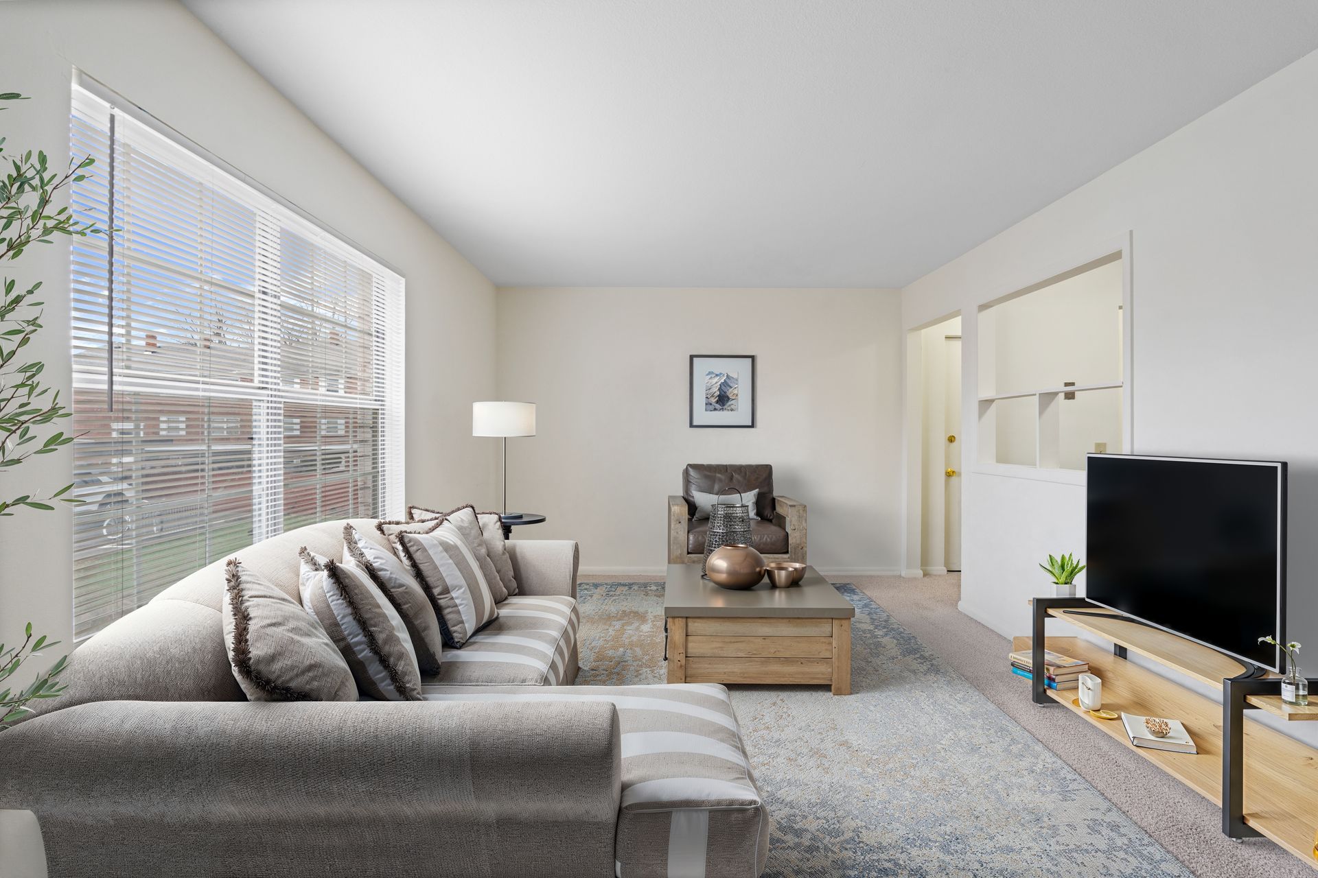 Photo of a den with plenty of natural light coming through the wide window