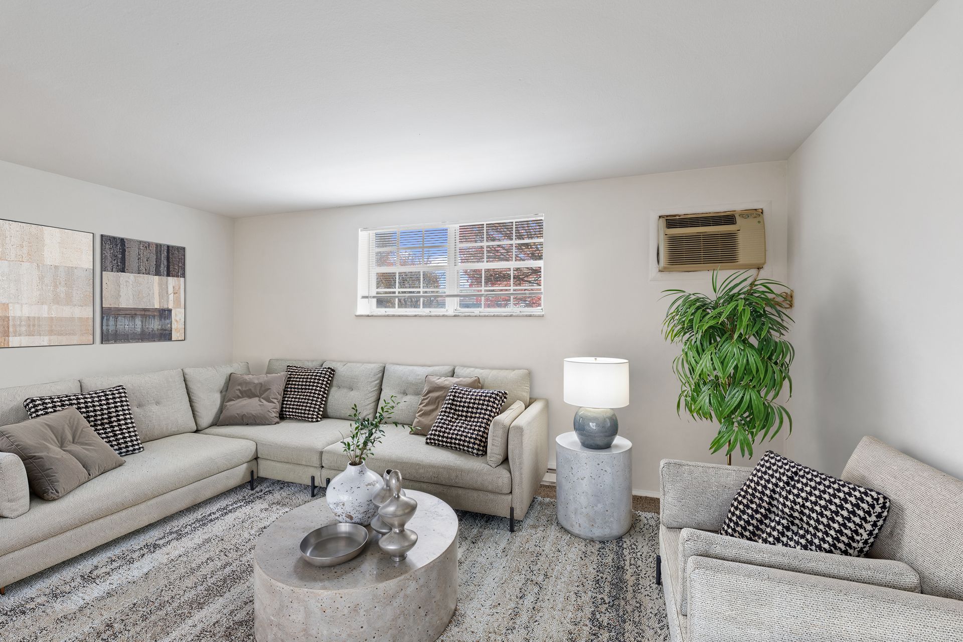 Photo of a cozy den showing a large, wrap around couch and and smaller arm chair