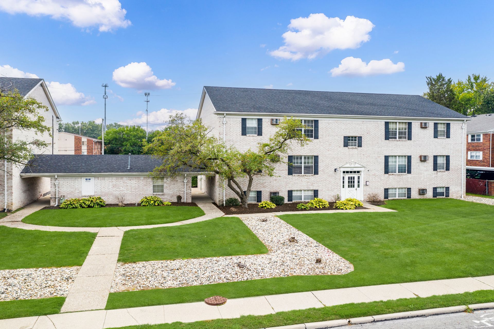Photo of a three story building showing a covered path between it and the next building